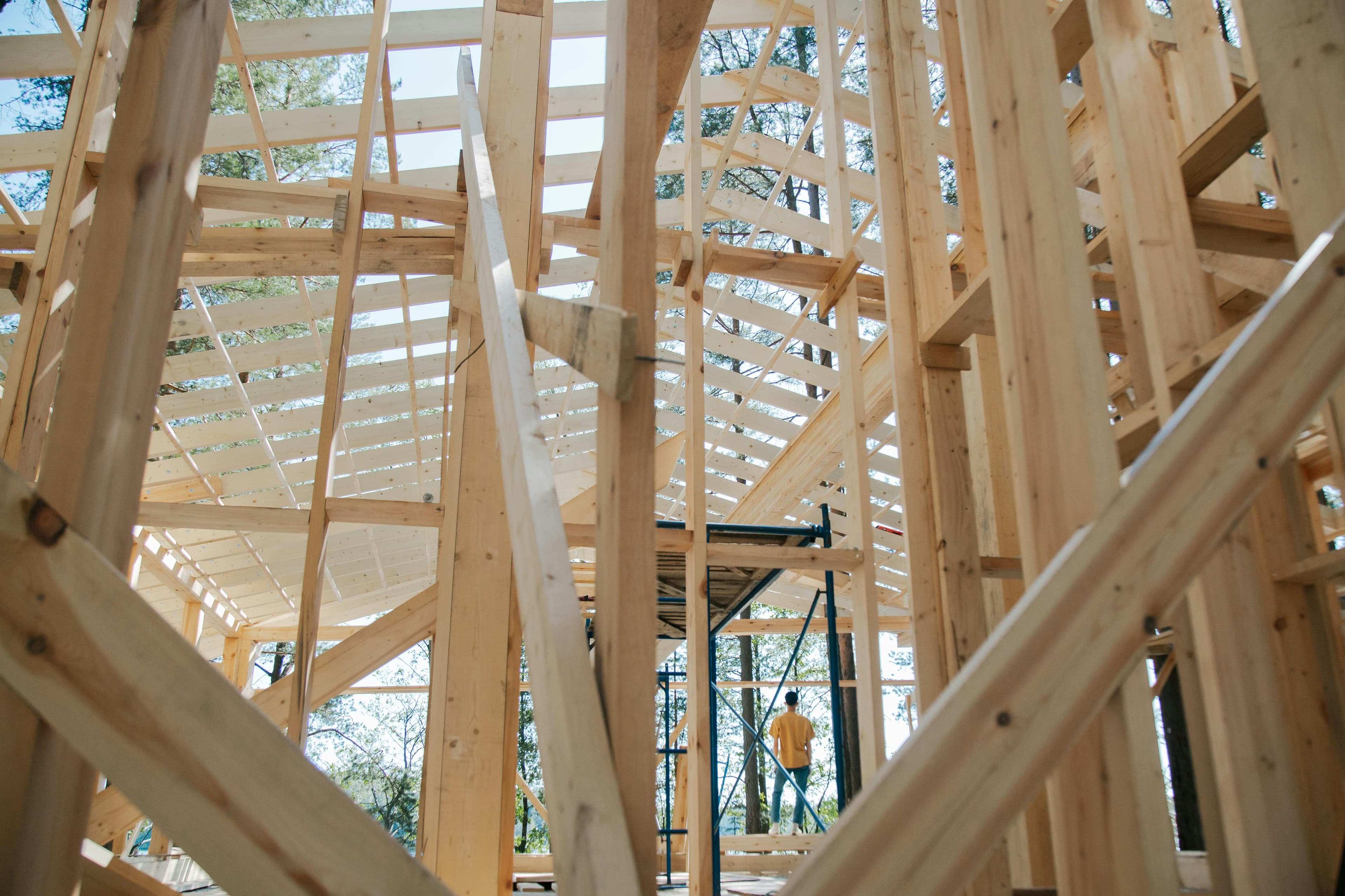 A wooden frame house under construction, showcasing building and development capabilities.